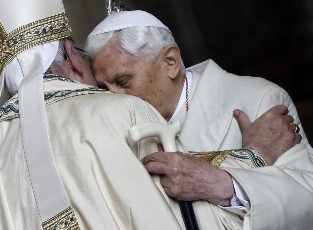 Pope Emeritus Benedict XVI, right, hugs Pope Francis in St. Peter's Basilica during the ceremony marking the start of the Holy Year, at the Vatican, Tuesday, Dec. 8, 2015. Pope Francis pushed open the great bronze doors of St. Peter's Basilica on Tuesday to launch his Holy Year of Mercy, declaring that mercy trumps moralizing in his Catholic Church. (AP Photo/Gregorio Borgia)