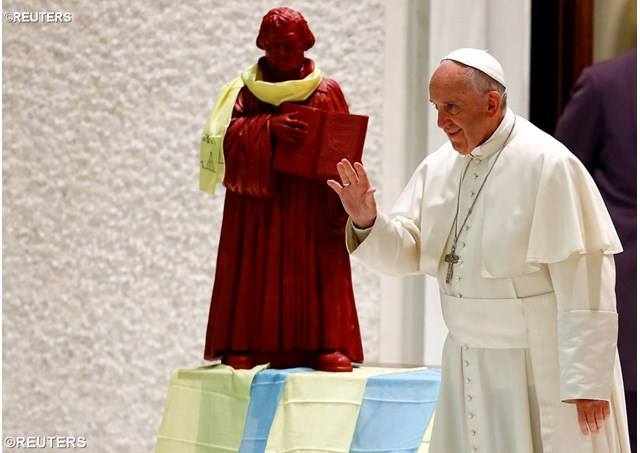 A Reuters File Photo shows Francis with a Statue of Martin Luther