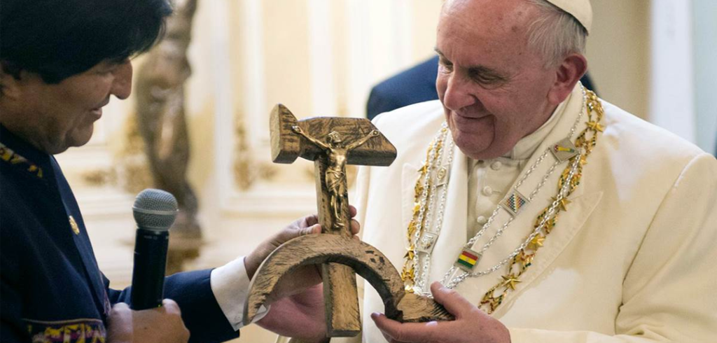 Pope Francis receives a crucifix fashioned into a communist hammer and sickle from Bolivian president Evo Morales.